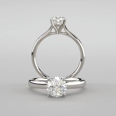 a white gold engagement ring with a single diamond