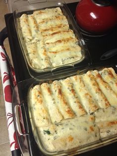 two pans filled with food sitting on top of a stove