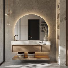 a modern bathroom with an oval mirror above the sink and two baskets on the counter