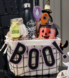 a halloween gift basket with booze, pumpkins, and other items in it