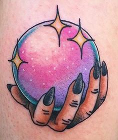 a woman's tattoo with two hands holding a pink ball and stars on it