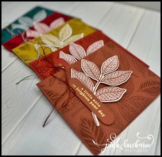 three different colored cards with leaves on them