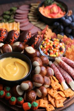 an assortment of snacks and dips on a platter