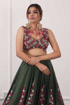 Dark green lehenga with placement floral embroidery. Paired with a padded blouse with all over floral bloom embroidery and dupatta with floral embroidery.
Components: 3
Pattern: Hand Embroidery
Type Of Work: Sequins, Floral
Neckline: Sweetheart Neck
Sleeve Type: Sleeveless
Fabric: Blouse and Dupatta: Net, Lehenga: Satin
Color: Green
Other Details: 
Attached inner lining
Lehenga:
Length: 45 inches
Blouse:
Length: 14
Padded
Crystal embellished hem
Floral tasselled back tie-up detailing
Dupatta:
Cr Dark Green Lehenga, Bloom Embroidery, Floral Lehenga, Net Blouses, Red Y, Green Lehenga, Padded Blouse, Net Lehenga, Satin Color