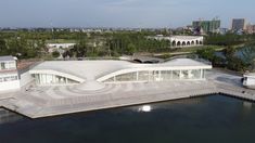 an aerial view of a building on the water