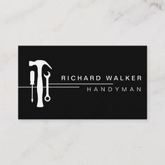 a black and white business card with a hammer and wrench