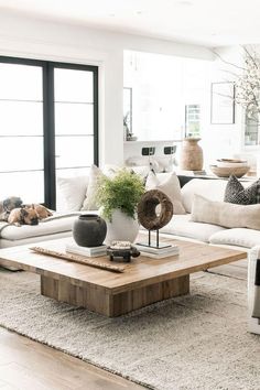 a living room filled with furniture and a dog laying on the floor next to it