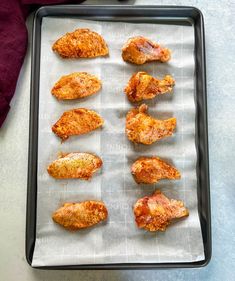 chicken wings on a baking sheet ready to be cooked