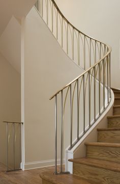 an empty staircase with railings and wood flooring