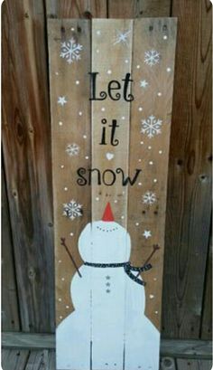 a wooden sign that says let it snow with a snowman in the center and stars on top