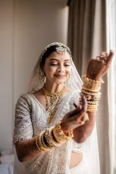 a woman in a wedding dress holding something up