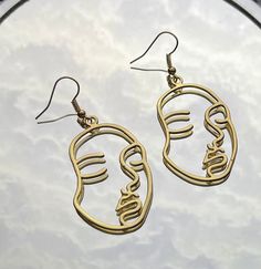 Gold Outlined Face Shaped Earring. Also available in Silver. Check out our other Face Shaped Earrings too! Artsy Gold Nickel-free Earrings, Artsy Gold Pierced Earrings, Artsy Gold Metal Earrings, Artsy Gold Brass Earrings, Gold Artsy Drop Earrings, Artsy Gold Drop Earrings, Gold Artsy Earrings For Party, Artsy Gold Earrings For Party, Artsy Gold Earrings