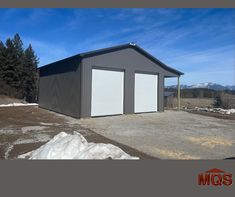 two garages are shown with snow on the ground and mountains in the backgroud