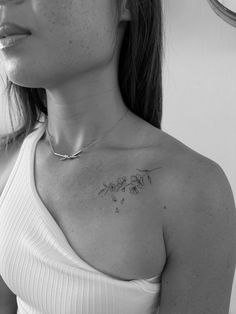 a woman with a flower tattoo on her chest