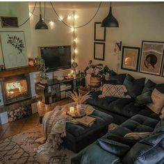 a living room filled with furniture and a fire place next to a wall mounted tv