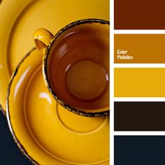 a yellow tea cup and saucer with matching color swatches in the middle, on a black table