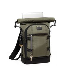 an open backpack with a laptop on it's back pocket and zippered closures