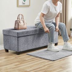 a person sitting on a bench with a handbag