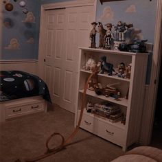 a child's bedroom with blue walls and toy animals on the bookcases