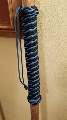 a blue and black rope wrapped around a wooden pole