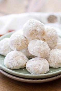 powdered sugar donuts on a green plate