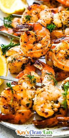 grilled shrimp with lemon wedges and parsley