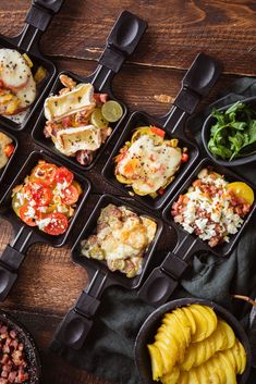 the meal is prepared and ready to be eaten on the wooden table with black trays