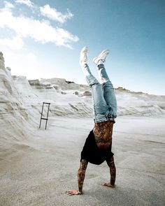 a man doing a handstand in the desert