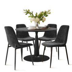 a round table with four chairs around it and a vase on the top that has flowers in it