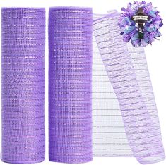 two rolls of purple mesh with flowers on top