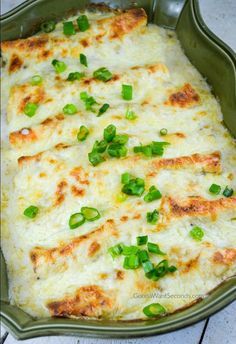 a casserole dish with cheese and green onions