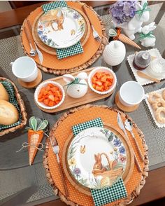 the table is set with carrots, bread and other dishes for easter dinner or brunch