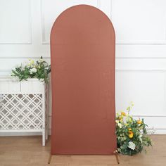 a pink backdrop with flowers on the floor and a planter in front of it