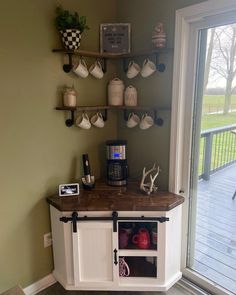 a coffee bar in the corner of a room with sliding glass doors leading to an outside deck