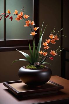 an arrangement of flowers in a black vase on a wooden table next to a window