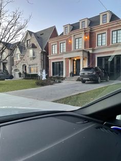 a car parked in front of a large house