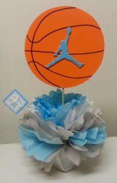 a basketball on top of a blue and white paper pom - pom ball