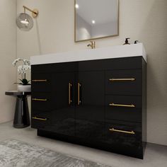 a black and white bathroom with gold handles on the cabinet doors, mirror over the sink