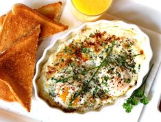 a white plate topped with an egg and toast