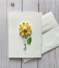 a card with a yellow flower on it