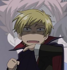 an anime character with blonde hair wearing a black jacket and red cape, standing in front of a gray background