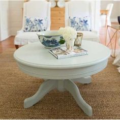 a white coffee table sitting on top of a rug