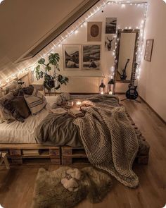 an attic bedroom is decorated with string lights