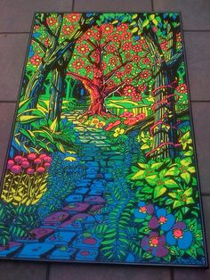 an image of a painting on the ground with flowers and trees around it, in bright colors