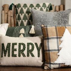 christmas pillows are sitting on a table