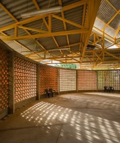 the inside of an empty building with lots of light coming in from the windows and shadows on the walls