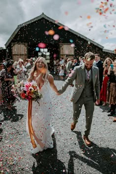 Bride wearing Madi Lane bridal walks through colourful confetti with her groom Magenta Wedding Colors, Shed Wedding, Magenta Wedding, Madi Lane, Confetti Photos, Embroidered Wedding Dress, Colourful Wedding, Velvet Bridesmaid Dresses