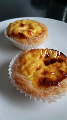 two small pastries sitting on top of a white plate