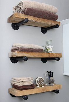 two wooden shelves holding towels and other items