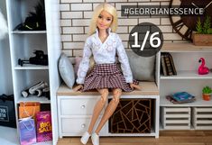 a barbie doll sitting on top of a white bench next to a book shelf and books